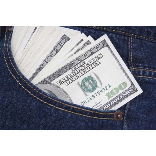 Some US $100 bills in a jeans pocket